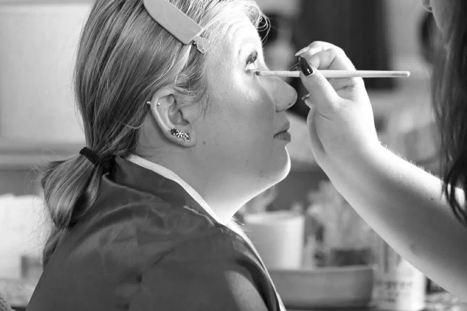 Makeup artist applying eye makeup